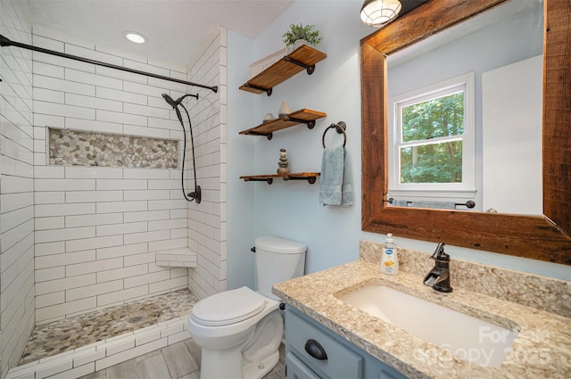 256 Timberland Loop, Mooresville, NC 28115 - full bathroom with vanity, a tile shower, recessed lighting, and a textured ceiling