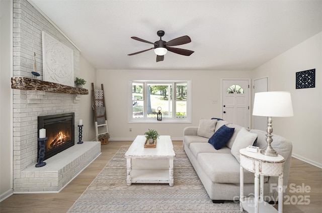 256 Timberland Loop, Mooresville, NC 28115 - living room with a ceiling fan, a brick fireplace, and light wood finished floors