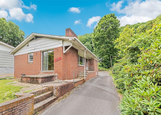 3575 Dellwood Rd, Waynesville, NC 28786 - view of home's exterior with brick siding and a chimney
