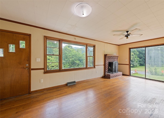 3575 Dellwood Rd, Waynesville, NC 28786 - unfurnished living room with hardwood / wood-style floors, a ceiling fan, ornamental molding, and a brick fireplace