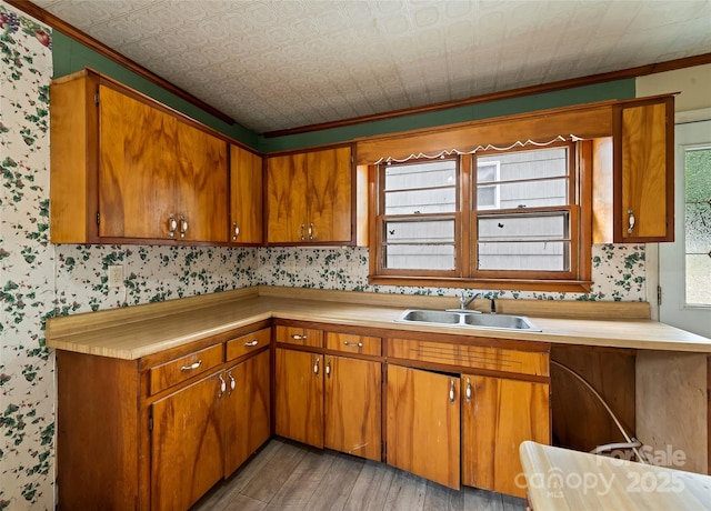 3575 Dellwood Rd, Waynesville, NC 28786 - kitchen with light countertops, light wood-type flooring, brown cabinets, ornamental molding, and wallpapered walls