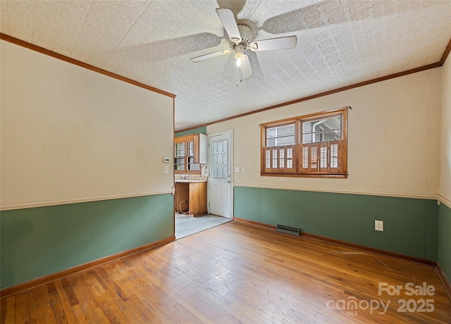 3575 Dellwood Rd, Waynesville, NC 28786 - unfurnished room with ornamental molding, an ornate ceiling, wood-type flooring, and a ceiling fan