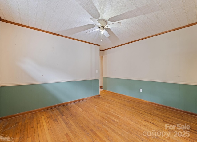 3575 Dellwood Rd, Waynesville, NC 28786 - spare room with crown molding, an ornate ceiling, hardwood / wood-style floors, and a ceiling fan