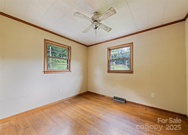 3575 Dellwood Rd, Waynesville, NC 28786 - spare room with healthy amount of natural light, crown molding, light wood-type flooring, and ceiling fan