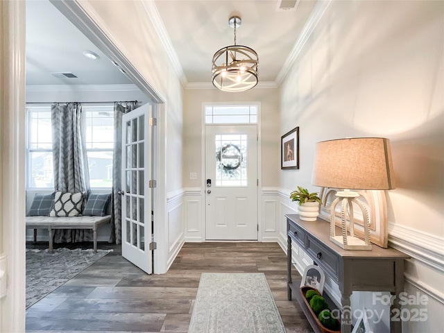1024 Laggan Ln Unit 255, Indian Trail, NC 28079 - foyer with a chandelier, ornamental molding, wainscoting, and dark wood-type flooring