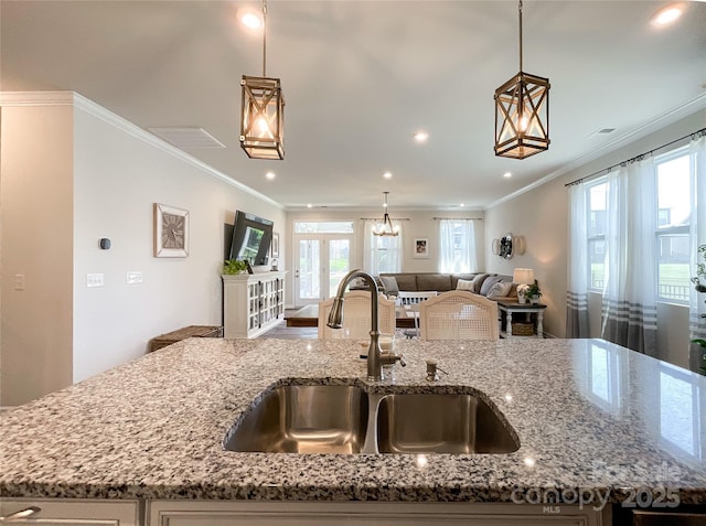 1024 Laggan Ln Unit 255, Indian Trail, NC 28079 - kitchen with open floor plan, crown molding, light stone countertops, plenty of natural light, and hanging light fixtures