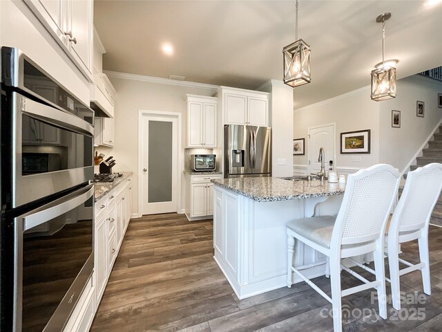 1024 Laggan Ln Unit 255, Indian Trail, NC 28079 - kitchen featuring stainless steel appliances, ornamental molding, light stone countertops, white cabinetry, and dark wood-type flooring