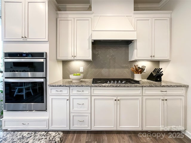 1024 Laggan Ln Unit 255, Indian Trail, NC 28079 - kitchen with appliances with stainless steel finishes, premium range hood, light stone countertops, crown molding, and white cabinetry