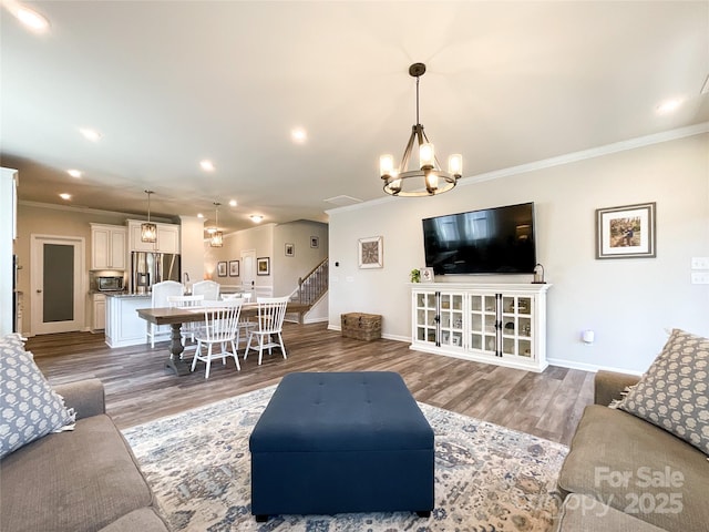 1024 Laggan Ln Unit 255, Indian Trail, NC 28079 - living room featuring crown molding, wood finished floors, a chandelier, stairway, and recessed lighting