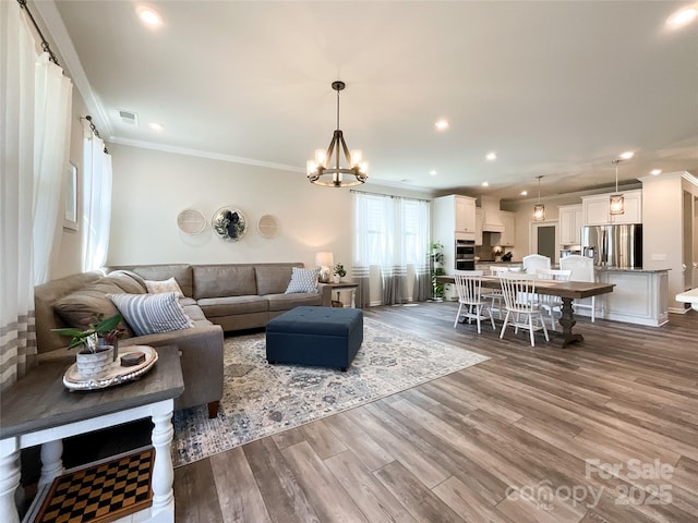 1024 Laggan Ln Unit 255, Indian Trail, NC 28079 - living area with ornamental molding, recessed lighting, dark wood-type flooring, and a chandelier