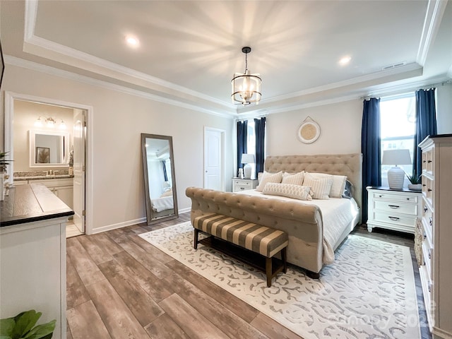 1024 Laggan Ln Unit 255, Indian Trail, NC 28079 - bedroom with a raised ceiling, a chandelier, wood finished floors, ornamental molding, and ensuite bath