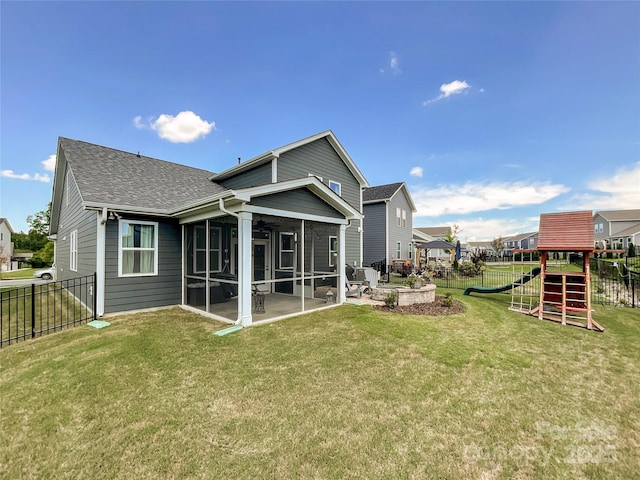 1024 Laggan Ln Unit 255, Indian Trail, NC 28079 - rear view of house with a sunroom, a playground, a shingled roof, a patio area, and a fenced backyard