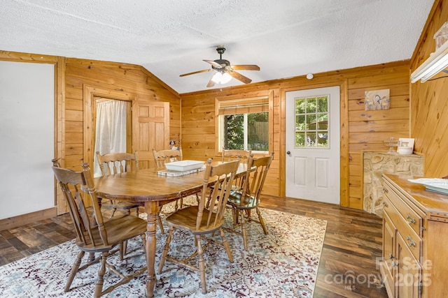 19 Timbers Edge Ln, Fairview, NC 28730 - dining space featuring wood walls, lofted ceiling, a ceiling fan, dark wood-type flooring, and a textured ceiling