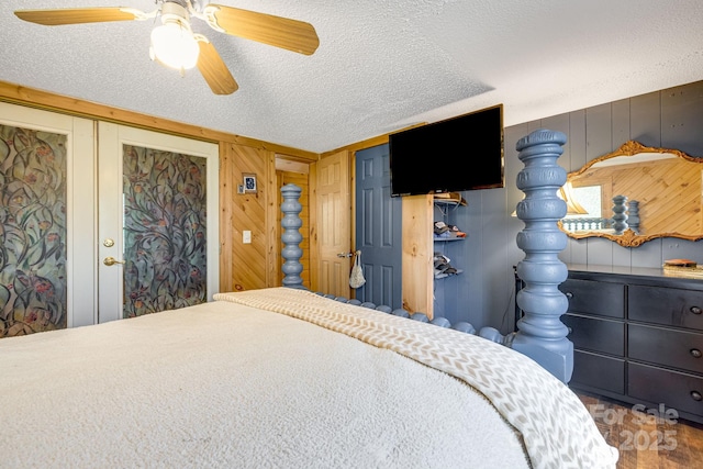 19 Timbers Edge Ln, Fairview, NC 28730 - bedroom with a textured ceiling, wooden walls, and ceiling fan