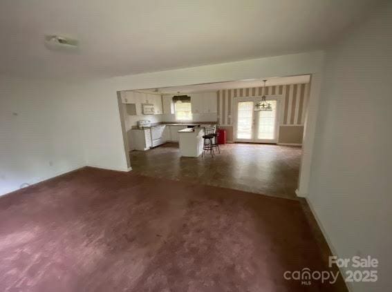 104 Edison St, Kings Mountain, NC 28086 - unfurnished living room featuring a chandelier