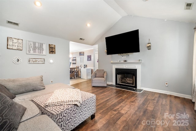 2108 Gambrel Way, Monroe, NC 28112 - living area featuring lofted ceiling, a fireplace with raised hearth, wood finished floors, and recessed lighting