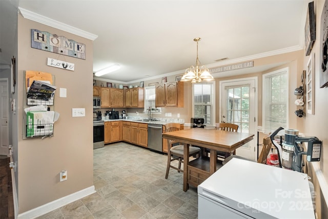 2108 Gambrel Way, Monroe, NC 28112 - kitchen with stainless steel appliances, light countertops, crown molding, decorative light fixtures, and a chandelier
