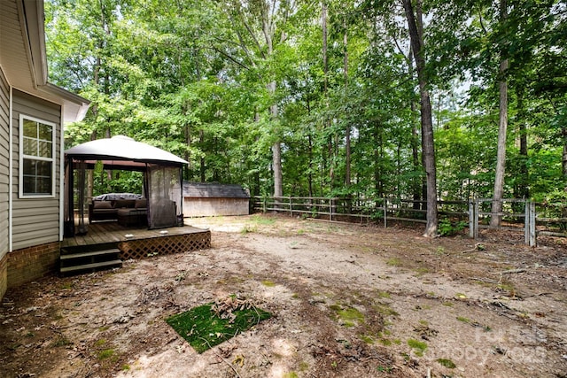 2108 Gambrel Way, Monroe, NC 28112 - fenced backyard with a gazebo, a wooden deck, and a storage shed