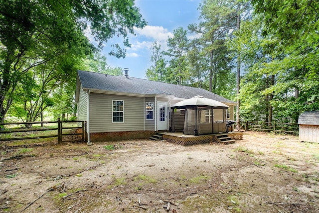 2108 Gambrel Way, Monroe, NC 28112 - rear view of property featuring a gazebo, a deck, a fenced backyard, roof with shingles, and a shed
