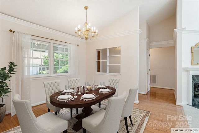 1105 Citation Cir, Hendersonville, NC 28739 - dining room with a chandelier, a premium fireplace, light wood-style floors, and lofted ceiling