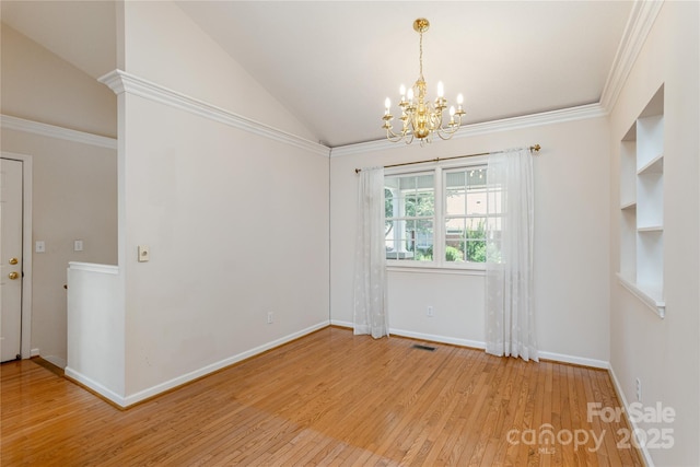 1105 Citation Cir, Hendersonville, NC 28739 - unfurnished dining area with a chandelier, wood finished floors, lofted ceiling, and crown molding