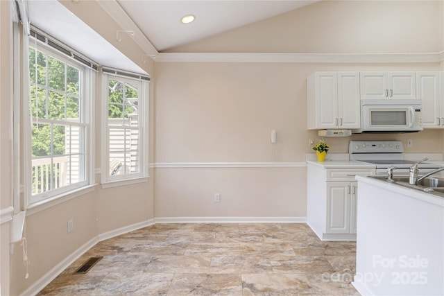 1105 Citation Cir, Hendersonville, NC 28739 - kitchen with white appliances, vaulted ceiling, white cabinets, light countertops, and recessed lighting