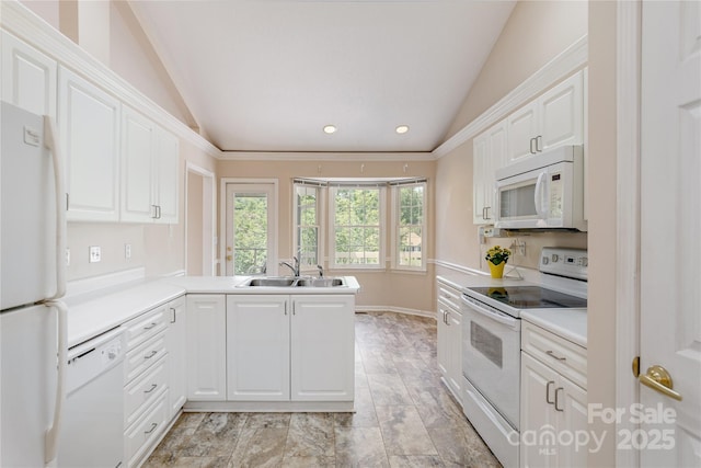 1105 Citation Cir, Hendersonville, NC 28739 - kitchen featuring white appliances, lofted ceiling, white cabinetry, a peninsula, and light countertops