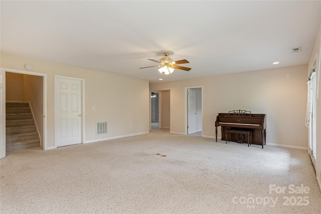 1105 Citation Cir, Hendersonville, NC 28739 - unfurnished living room with ceiling fan, carpet, stairway, and recessed lighting