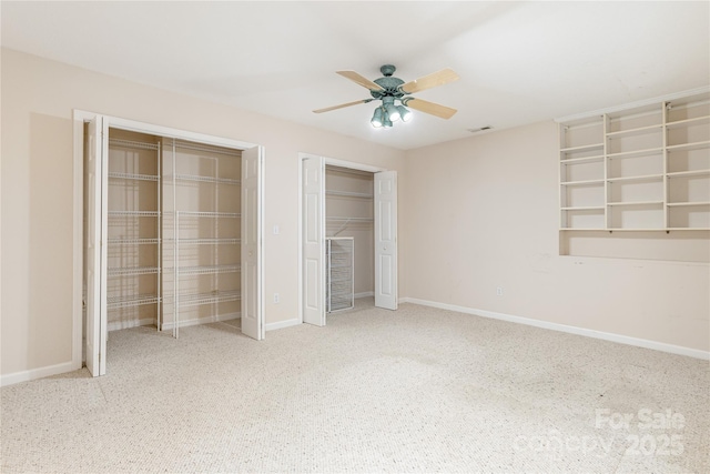 1105 Citation Cir, Hendersonville, NC 28739 - unfurnished bedroom featuring multiple closets, carpet flooring, and a ceiling fan