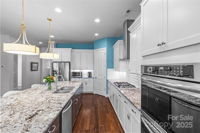 4928 Providence Country Club Dr, Charlotte, NC 28277 - kitchen featuring stainless steel appliances, white cabinetry, wall chimney exhaust hood, decorative backsplash, and pendant lighting