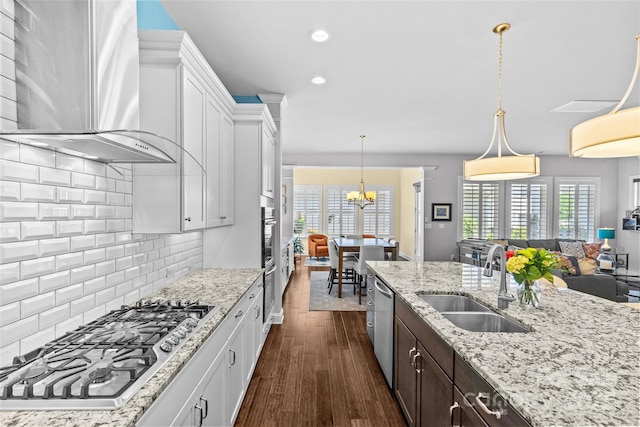 4928 Providence Country Club Dr, Charlotte, NC 28277 - kitchen with stainless steel appliances, wall chimney range hood, dark wood finished floors, backsplash, and white cabinetry
