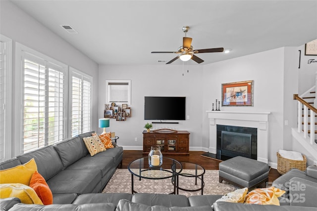 4928 Providence Country Club Dr, Charlotte, NC 28277 - living area with stairway, dark wood-style floors, ceiling fan, and a glass covered fireplace