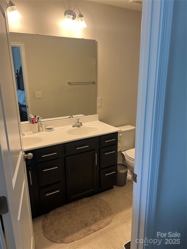 1076 Tangle Ridge Dr SE, Concord, NC 28025 - bathroom featuring double vanity and toilet
