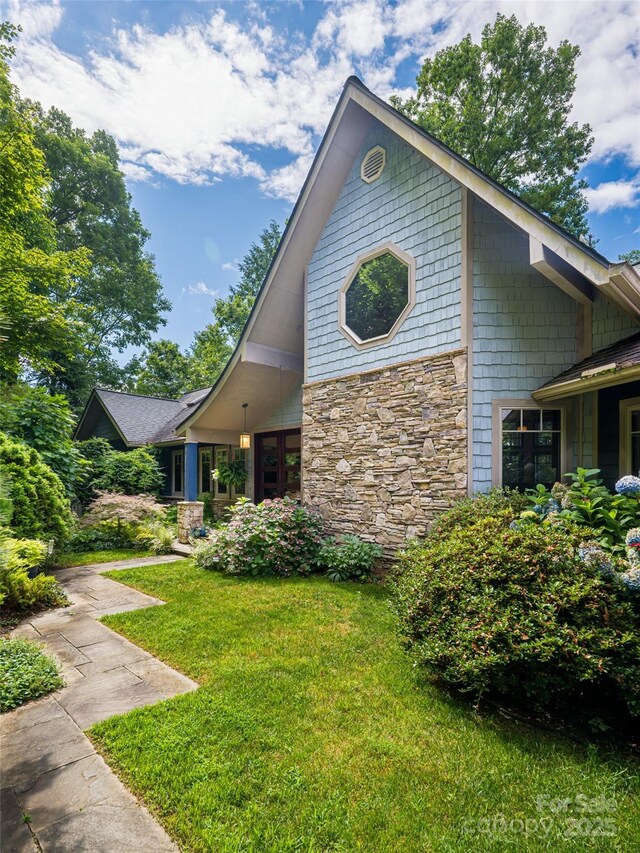 935 Whites Lake Blvd, Saluda, NC 28773 - view of front of home with stone siding and a front yard