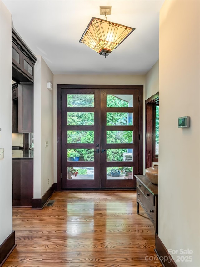 935 Whites Lake Blvd, Saluda, NC 28773 - entryway featuring plenty of natural light, light wood-type flooring, and french doors