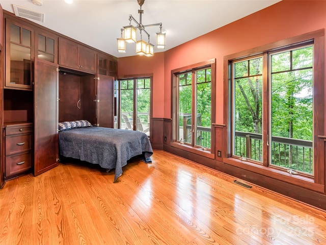 935 Whites Lake Blvd, Saluda, NC 28773 - bedroom with light wood finished floors and a wainscoted wall