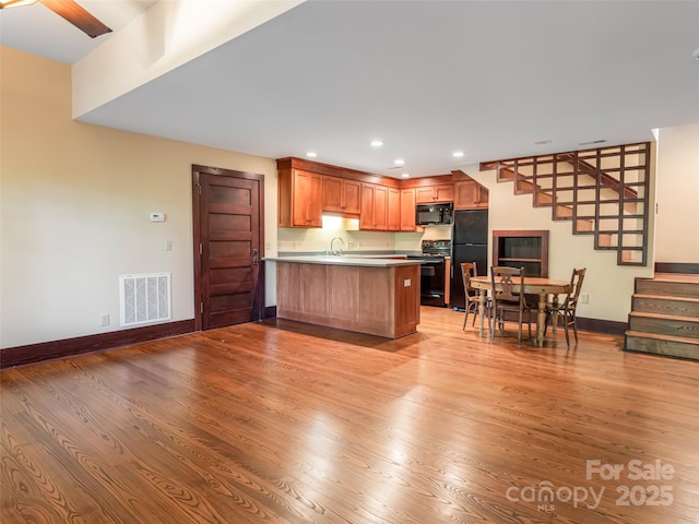 935 Whites Lake Blvd, Saluda, NC 28773 - kitchen featuring black appliances, a peninsula, light wood finished floors, and recessed lighting