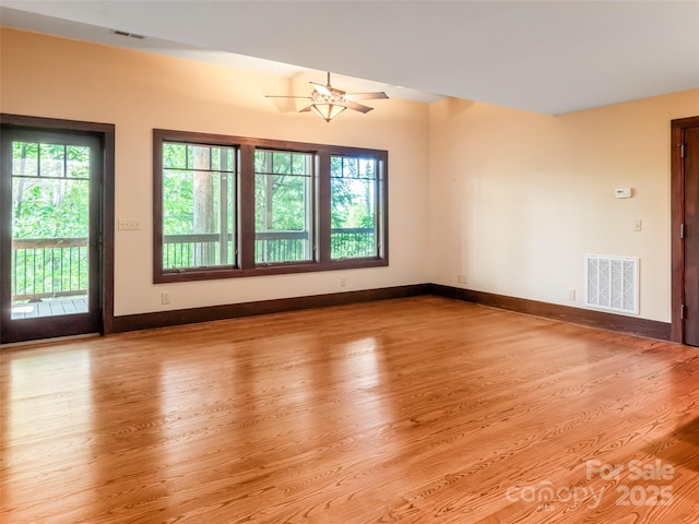 935 Whites Lake Blvd, Saluda, NC 28773 - unfurnished room featuring plenty of natural light, wood finished floors, and a ceiling fan