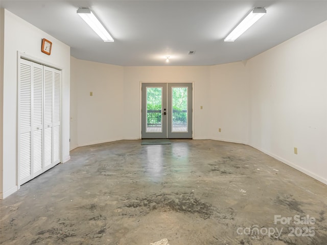 935 Whites Lake Blvd, Saluda, NC 28773 - unfurnished room featuring unfinished concrete flooring and french doors