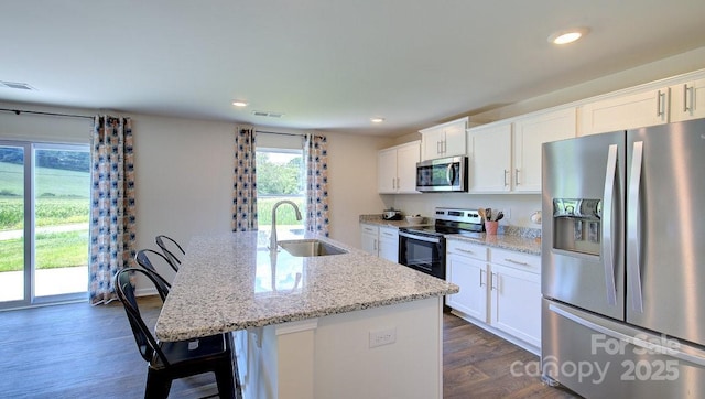 12 Wildbrook Dr, Waynesville, NC 28785 - kitchen with stainless steel appliances, dark wood-style floors, a center island with sink, white cabinets, and recessed lighting