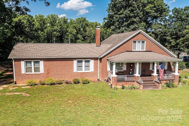 2035 Kool Park Rd NE, Hickory, NC 28601 - view of front of house featuring a chimney, covered porch, brick siding, a front yard, and roof with shingles
