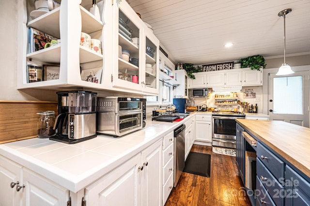 2035 Kool Park Rd NE, Hickory, NC 28601 - kitchen with stainless steel appliances, white cabinets, dark wood finished floors, glass insert cabinets, and decorative light fixtures