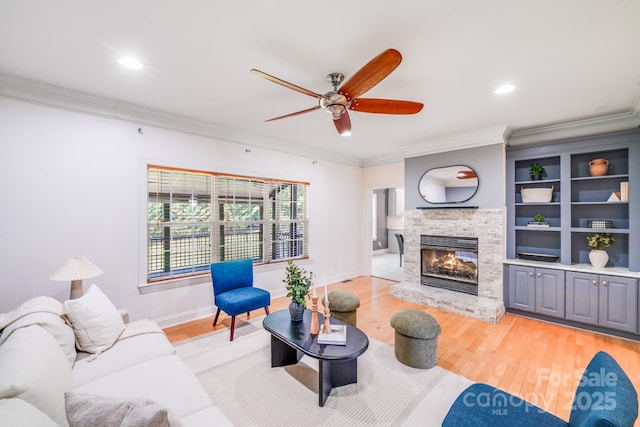 4525 Chestwood Ct, Rock Hill, SC 29732 - living area featuring crown molding, light wood-style flooring, a stone fireplace, a ceiling fan, and recessed lighting
