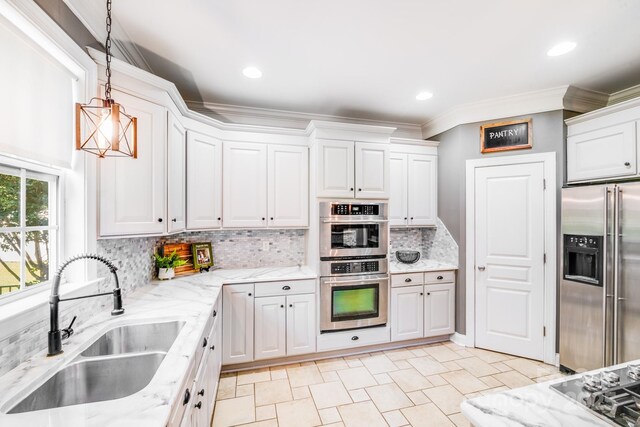 4525 Chestwood Ct, Rock Hill, SC 29732 - kitchen with stainless steel appliances, white cabinetry, decorative backsplash, decorative light fixtures, and ornamental molding