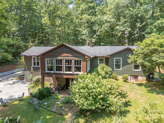 85 Red Bird Rd, Tryon, NC 28782 - view of front of home featuring a front yard, a patio, a chimney, and roof with shingles
