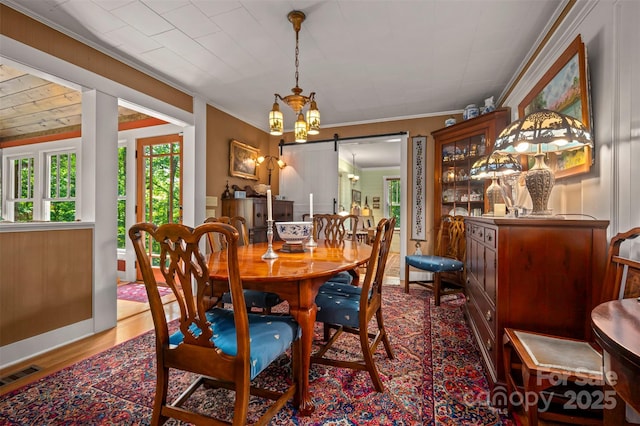 85 Red Bird Rd, Tryon, NC 28782 - dining space with a barn door, crown molding, and wood finished floors