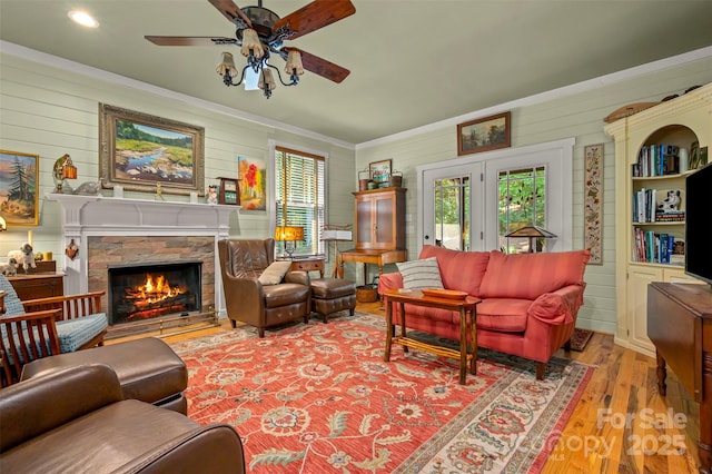 85 Red Bird Rd, Tryon, NC 28782 - living area featuring ceiling fan, plenty of natural light, wooden walls, wood finished floors, and a fireplace