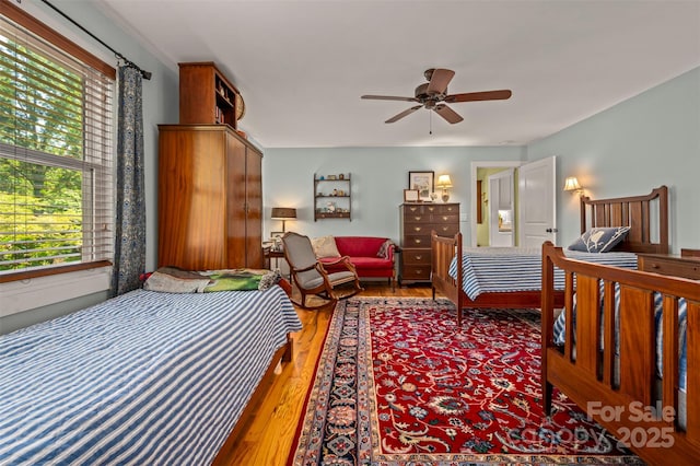 85 Red Bird Rd, Tryon, NC 28782 - bedroom with multiple windows, wood finished floors, and ceiling fan