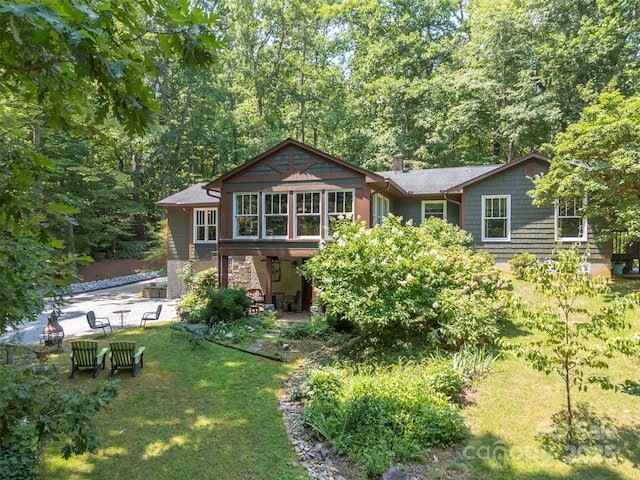 85 Red Bird Rd, Tryon, NC 28782 - back of house featuring a lawn and a patio