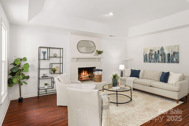 8806 Golf Ridge Dr, Charlotte, NC 28277 - living room featuring a raised ceiling, dark wood-type flooring, a brick fireplace, and recessed lighting